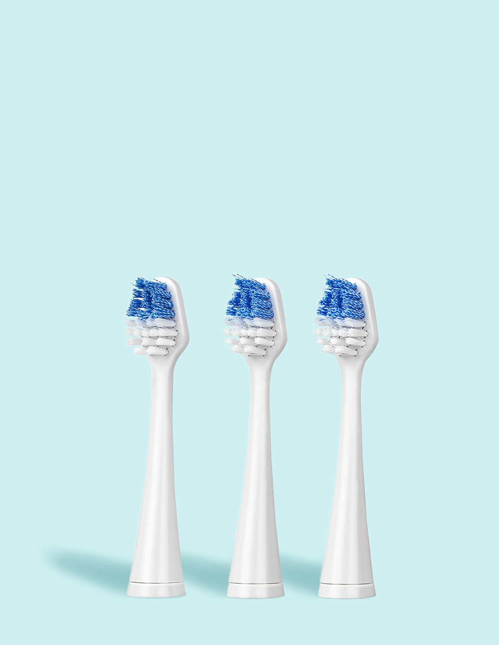 Three white electric toothbrush heads with blue bristle patterns on a light blue background